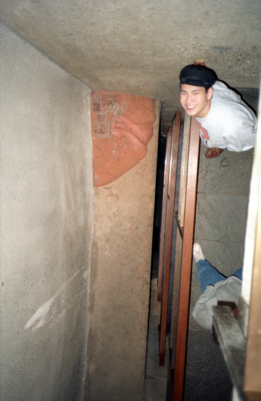 a guy climbing into a room that is very dirty