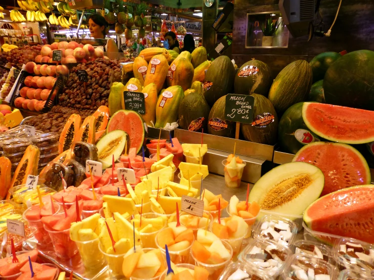 various fresh fruit and vegetables are displayed on tables