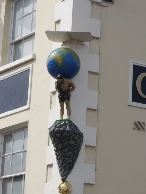 there is a blue and green ball on the side of a building