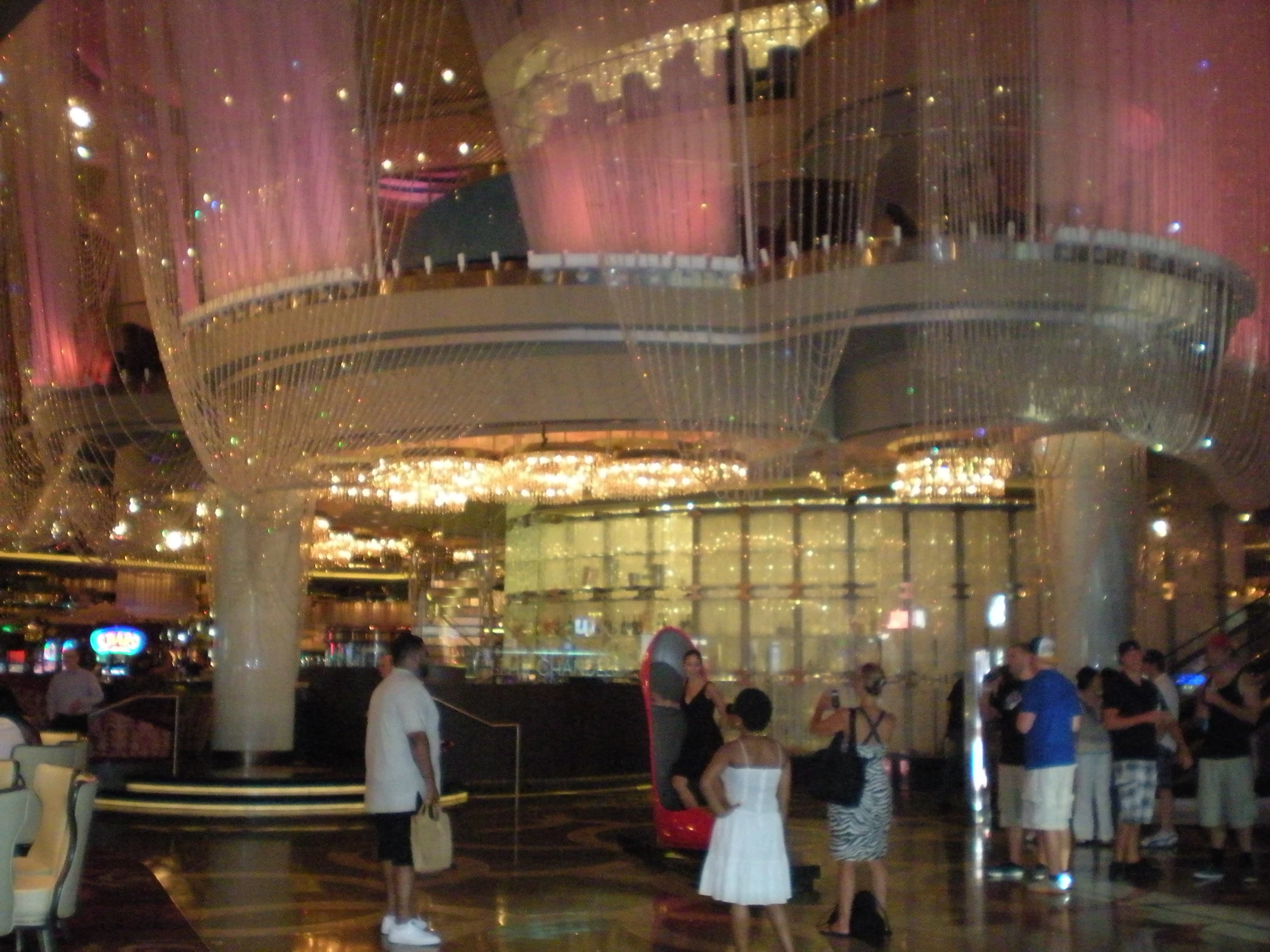 several people are in the middle of a foyer with lights