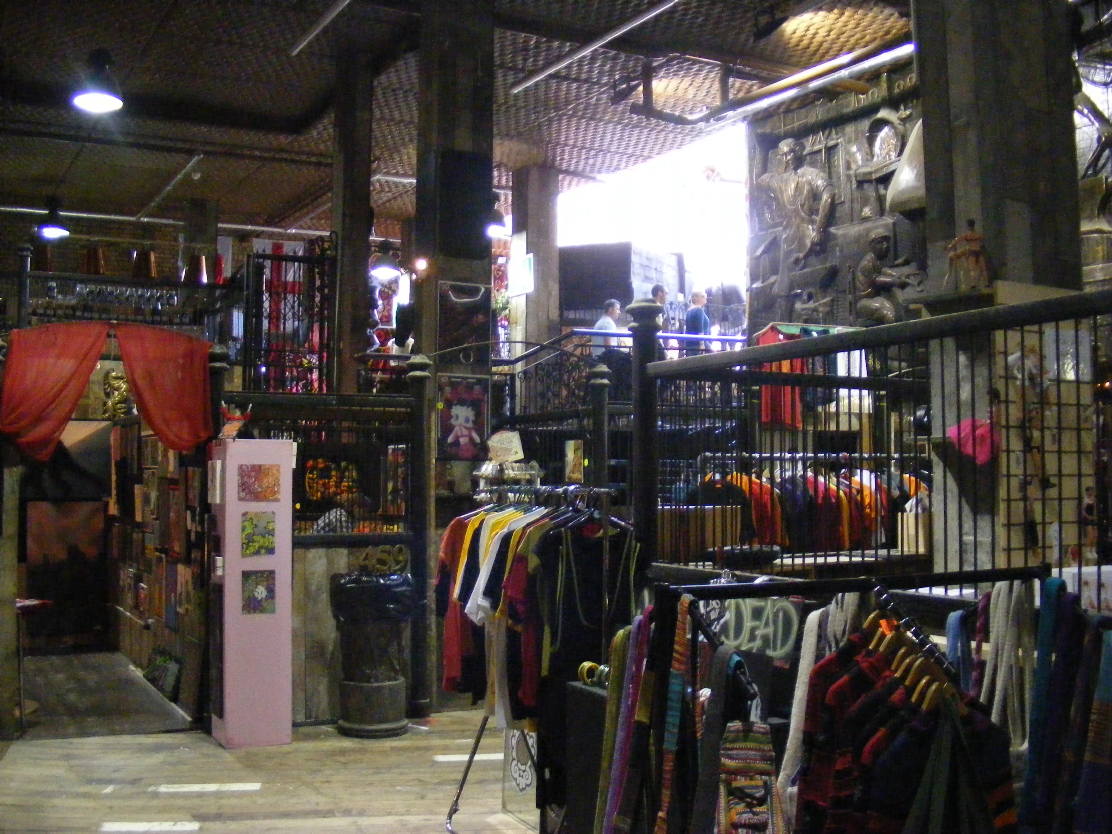 inside the store with several shirts on racks