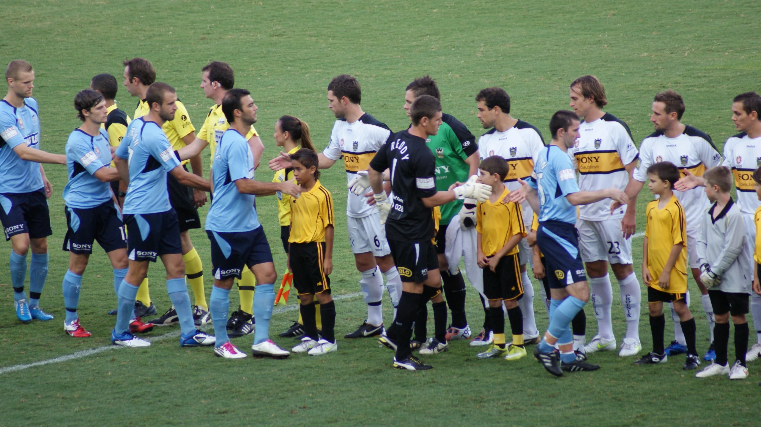 a soccer team in a huddle together on the field