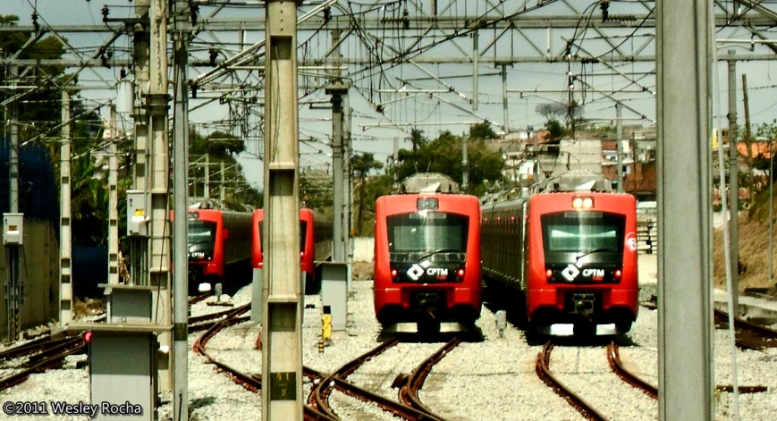 a set of three train tracks that have a group of trains on one end of them