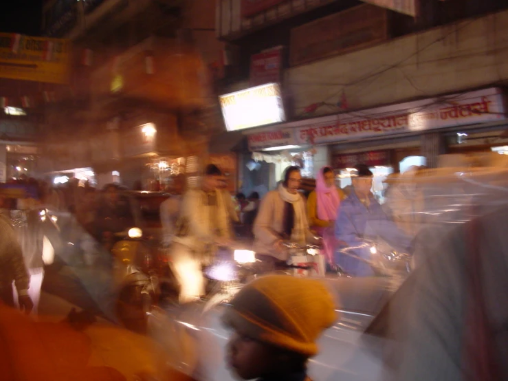 blurred image of people riding bikes and walking on the street