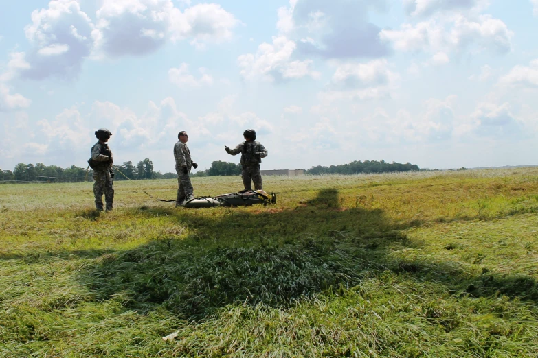 four people standing in the middle of a field