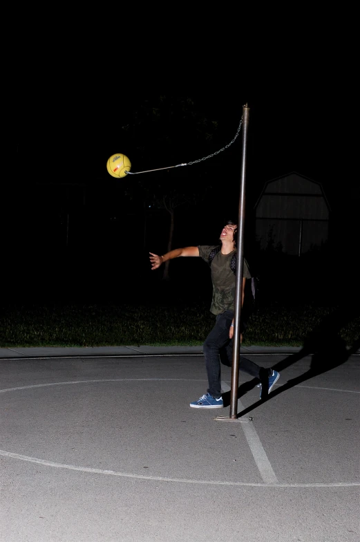 a man is holding a yellow frisbee in a parking lot