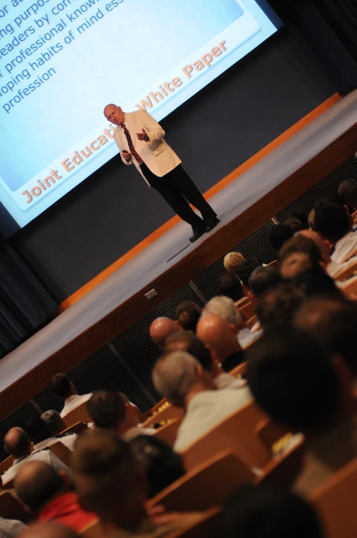 an auditorium full of people is listening to a lecture