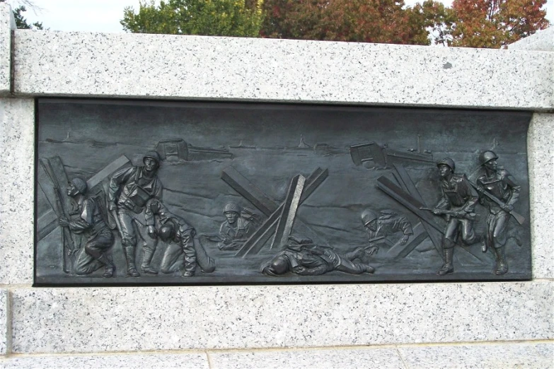 a carving in the wall depicts men holding crosses