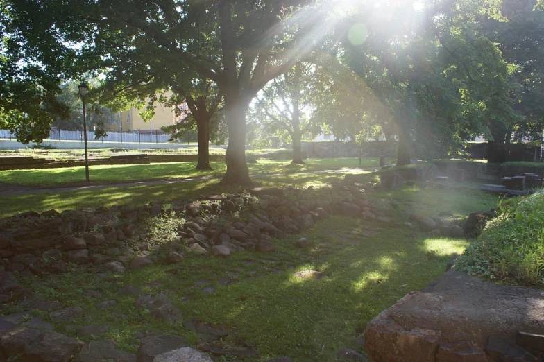 a small park with rocks and benches and shade