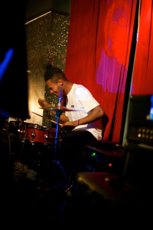 a man sitting at a table playing drums