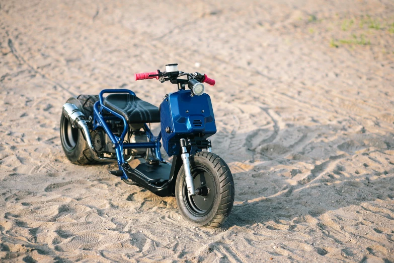 a motorcycle is sitting on the beach sand