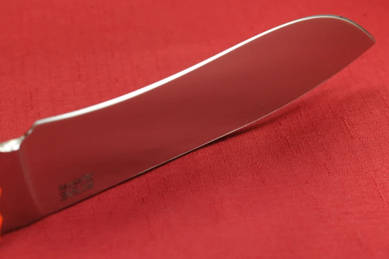 a knife with a red edge on a red surface