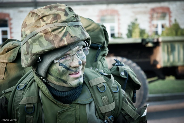 a man in camouflage is wearing military gear