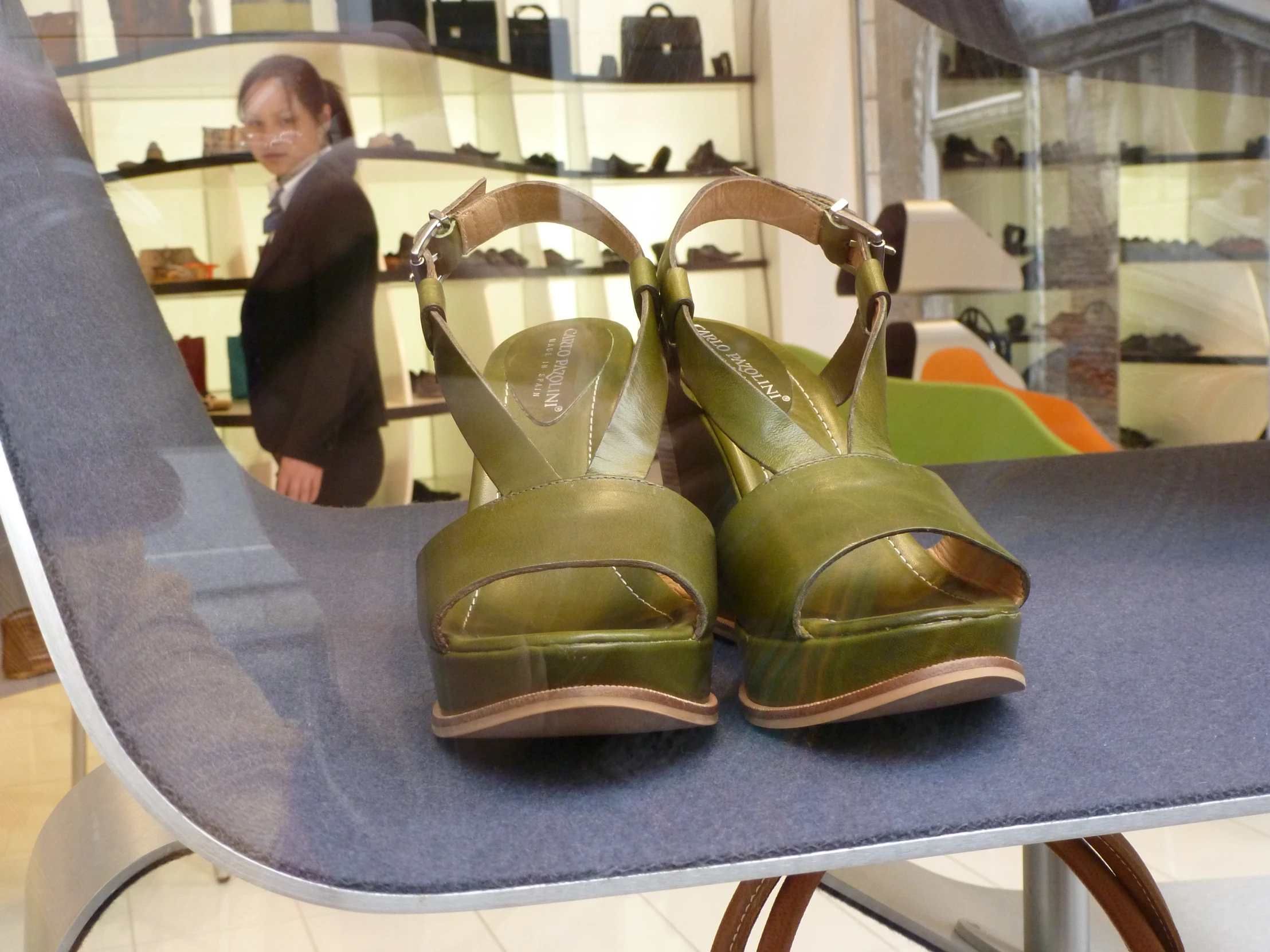 some green shoes that are on a display table