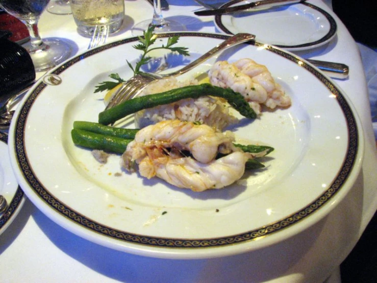 a dinner plate is adorned with grilled shrimp and asparagus
