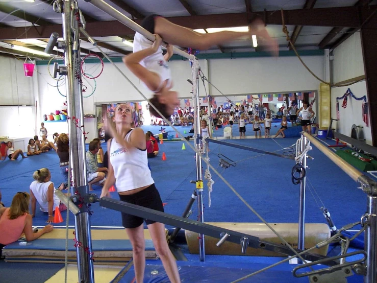 a person on a pole and another person doing tricks