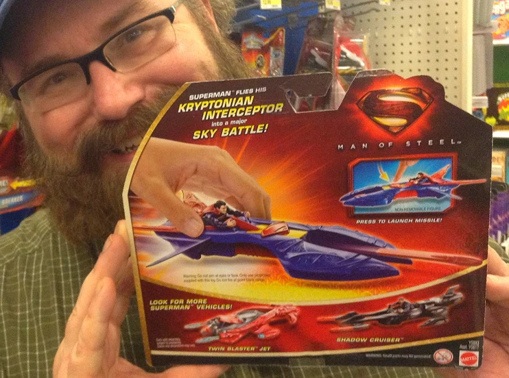 a man opening a toy box showing his superman design