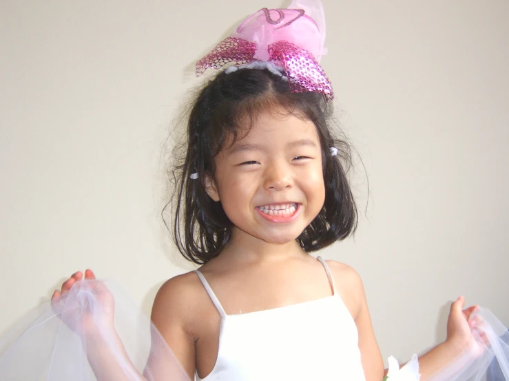 little girl wearing tulle and pink bows on her head