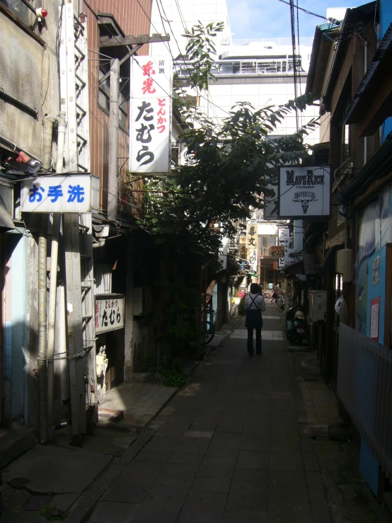 a narrow building with an alley with signs on it