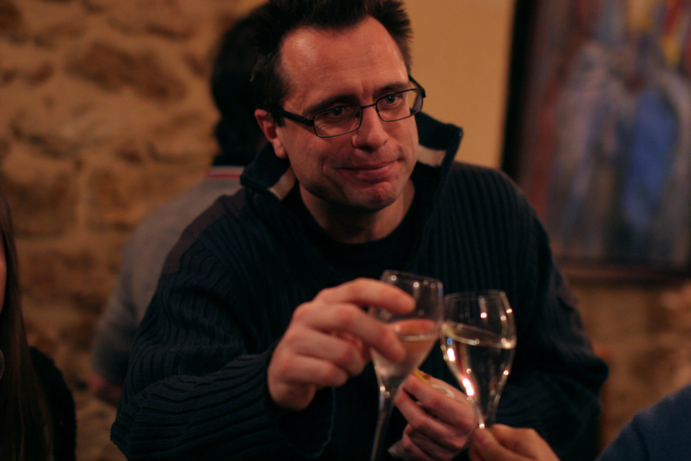 a man holding a wine glass in a room