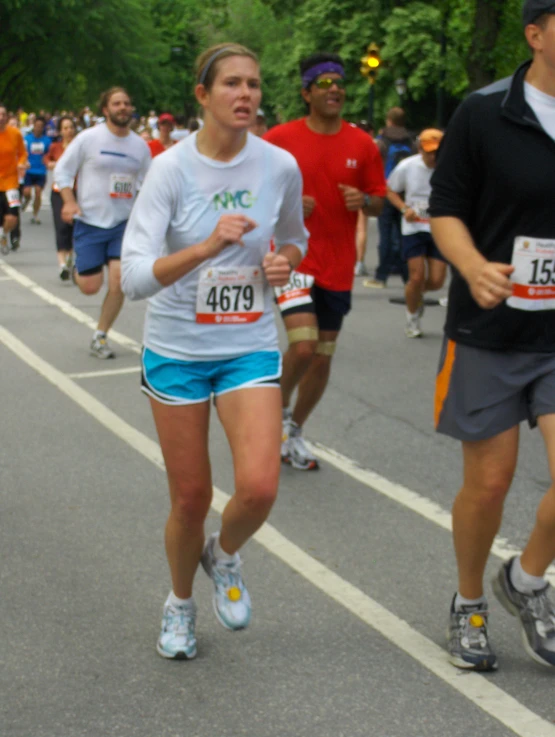 a group of people running in the street