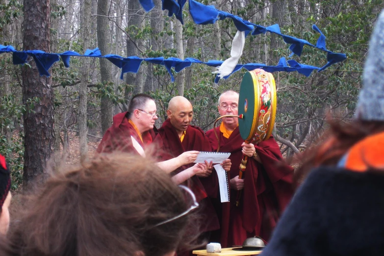 a group of monks in traditional garb are talking