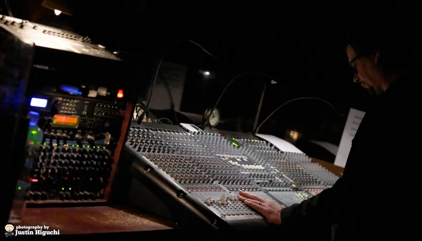 a man that is in front of some sound equipment