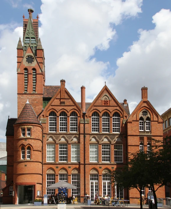 a building with a tall tower with a clock at the top of it