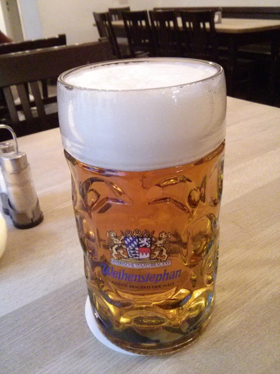 a close up of a glass of beer on a table