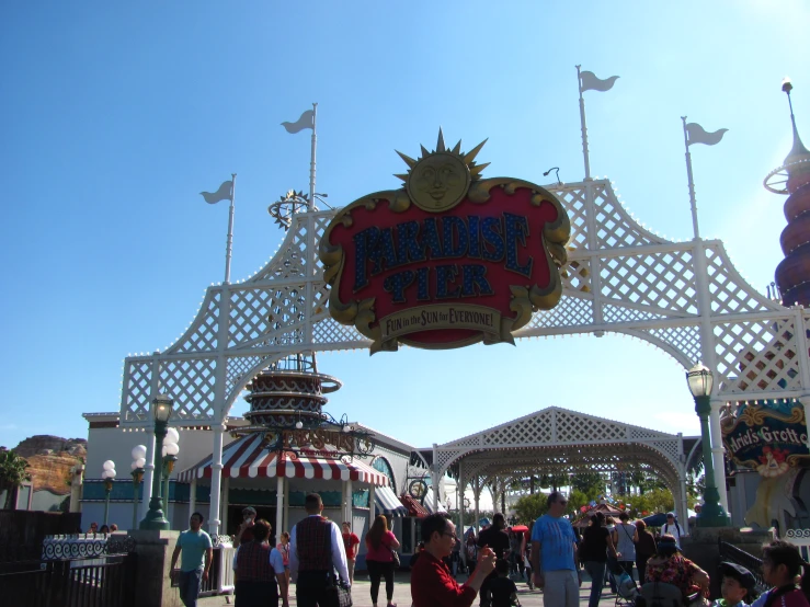 the entrance to an amut park, which is decorated like a canopy and has a sign reading, summer fun, for s