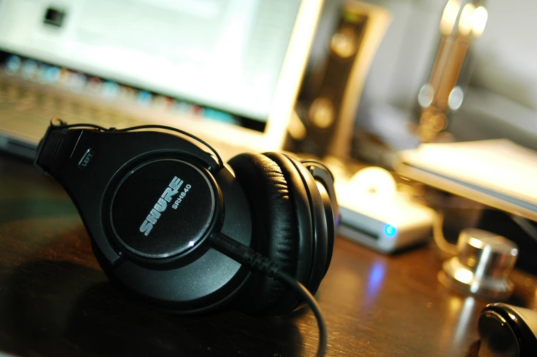 there is a close up picture of headphones on a desk