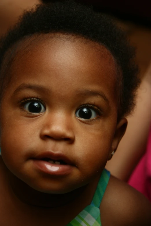 a close up of a child with big eyes