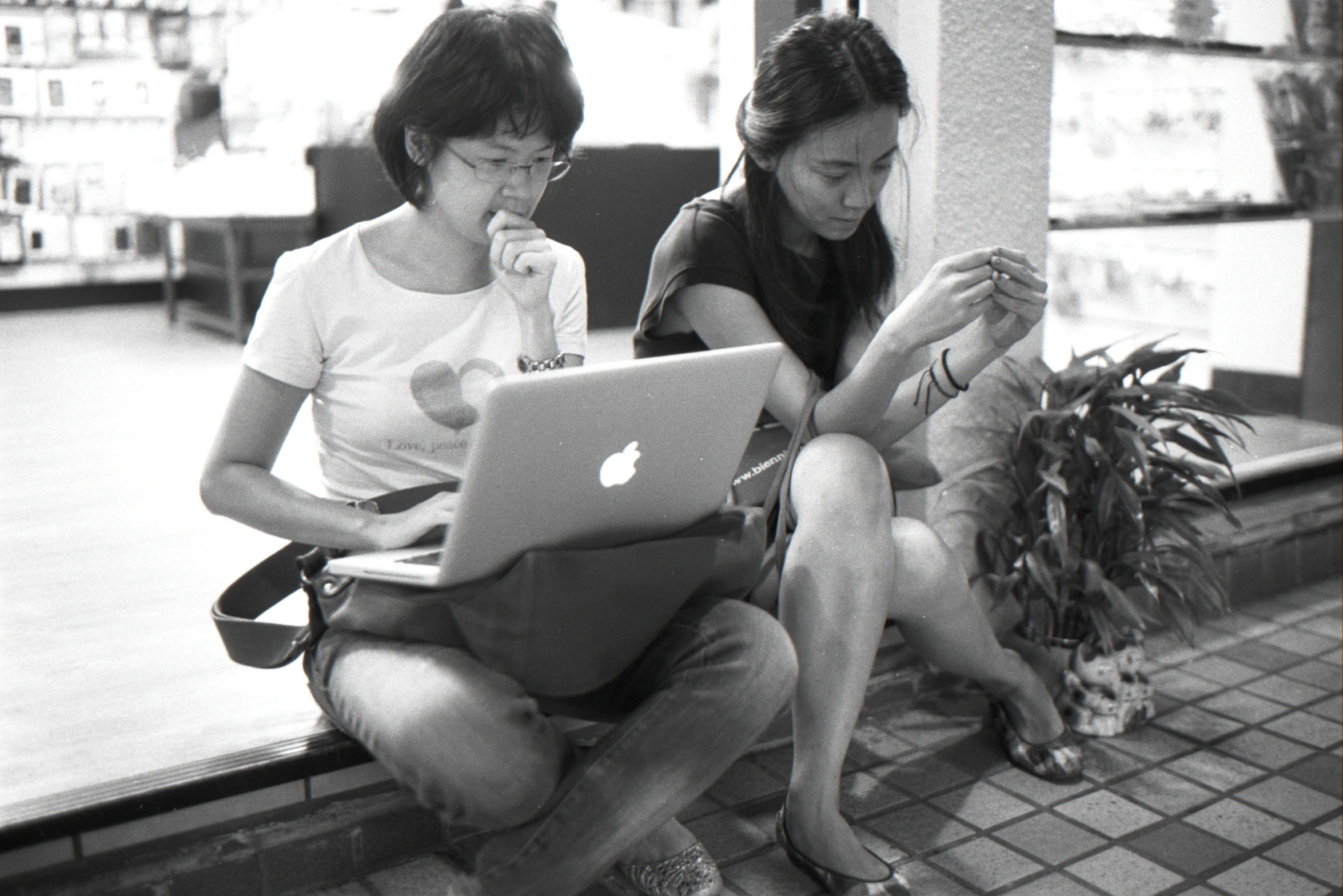 black and white po of two women with laptops