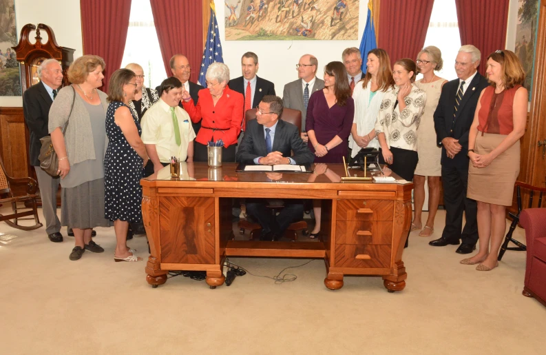 several people standing around a table in a room