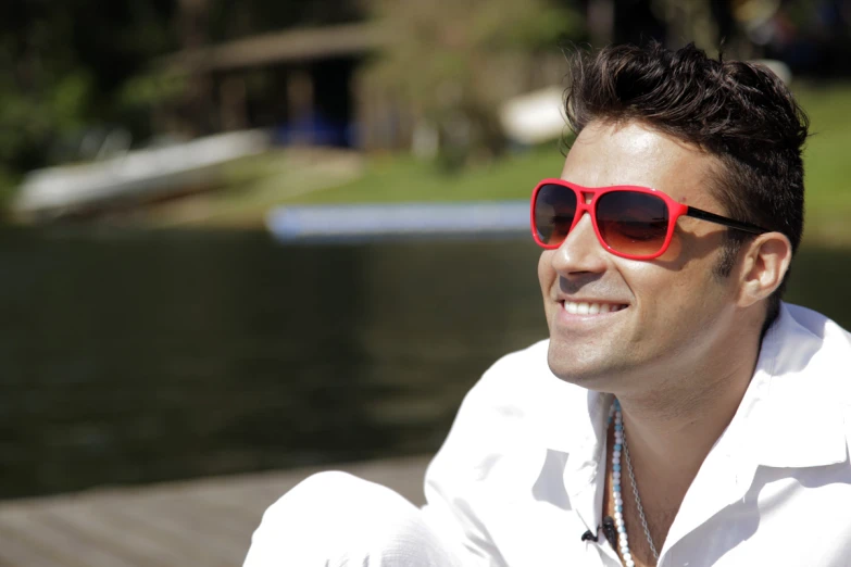 the man with his bright red sunglasses makes sure to be enjoying his sunny day