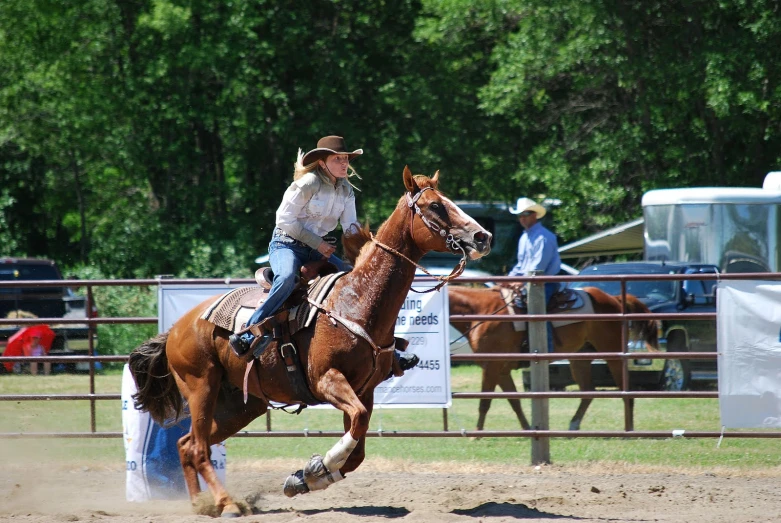 the woman in cowboy hats rides her horse