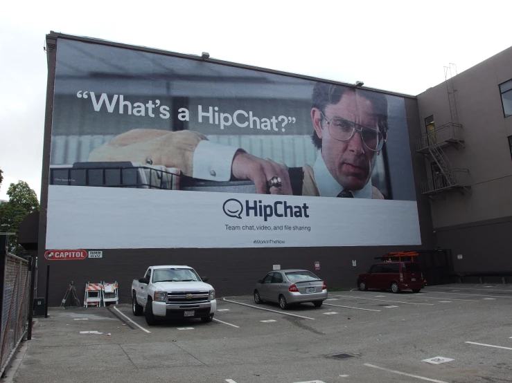 large billboard advertising for a movie starring of man in a white suit