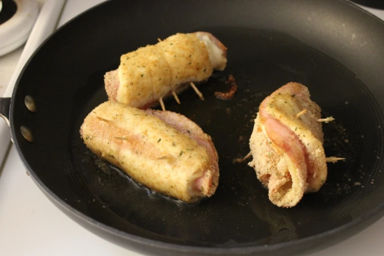 the sandwich is in the pan on the stove