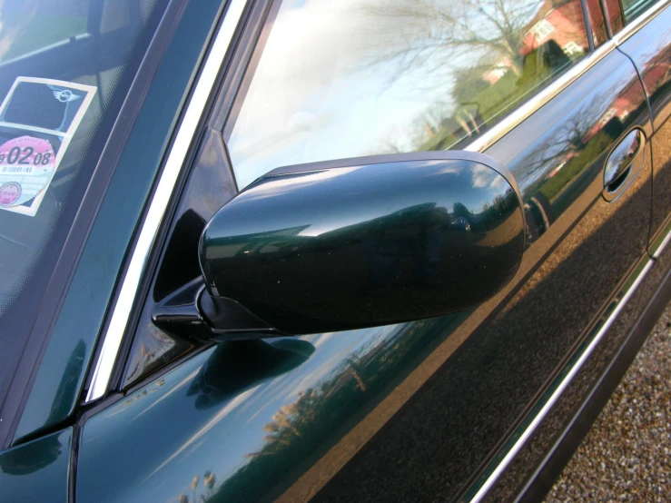 a side mirror of a car with a sticker in it