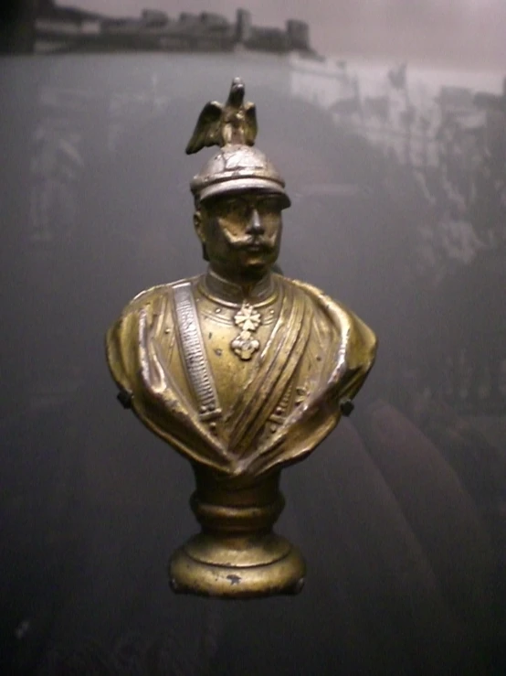 a gold statue that looks like it is from the early twentieth century
