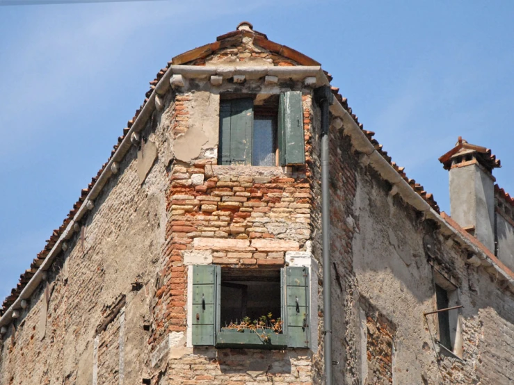 an old building with shutters open to let in light