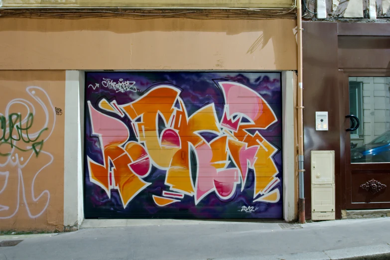 a colorful graffitti wall is shown with brown doors