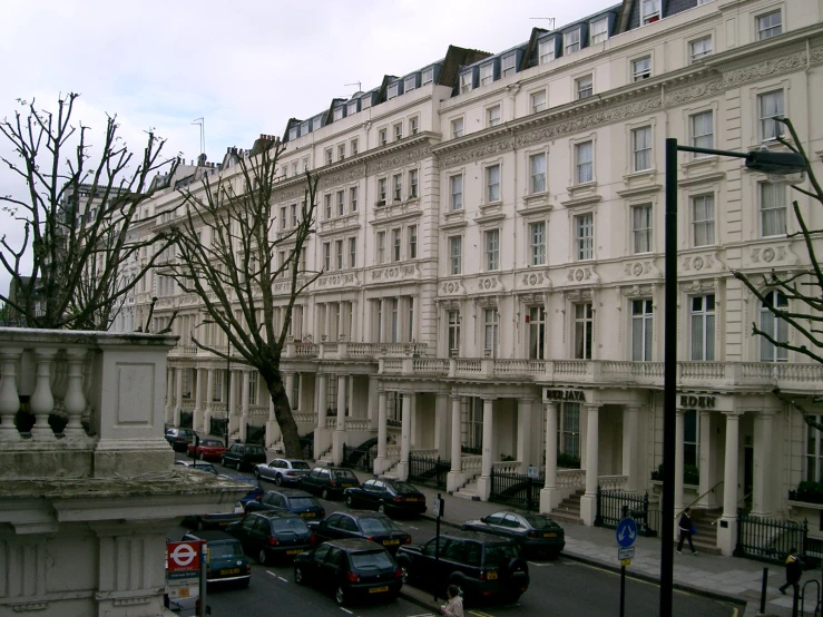 a view of an old street with a lot of cars parked on the road