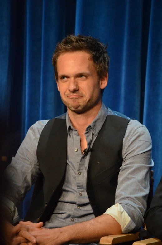 a man sitting down and looking to the side