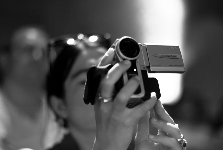 a woman is holding a camera up to take pictures