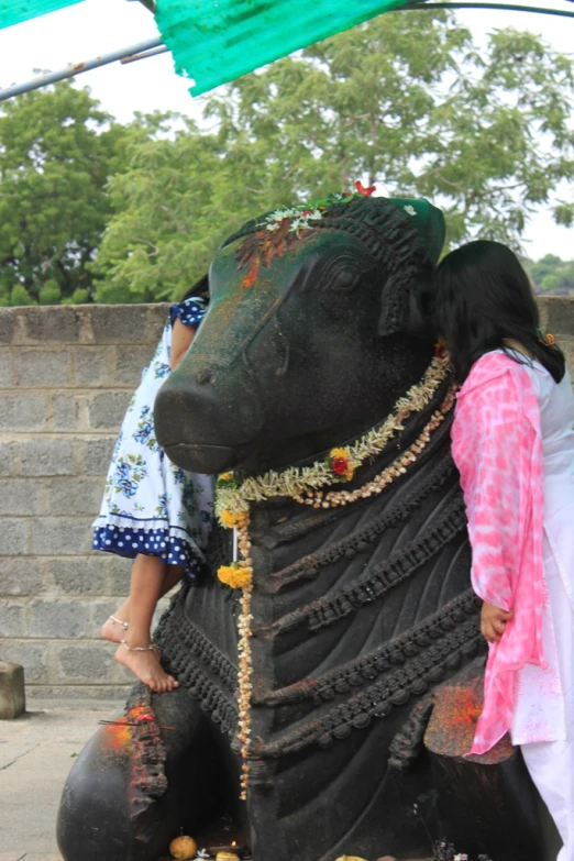 a woman on a large sculpture of a elephant