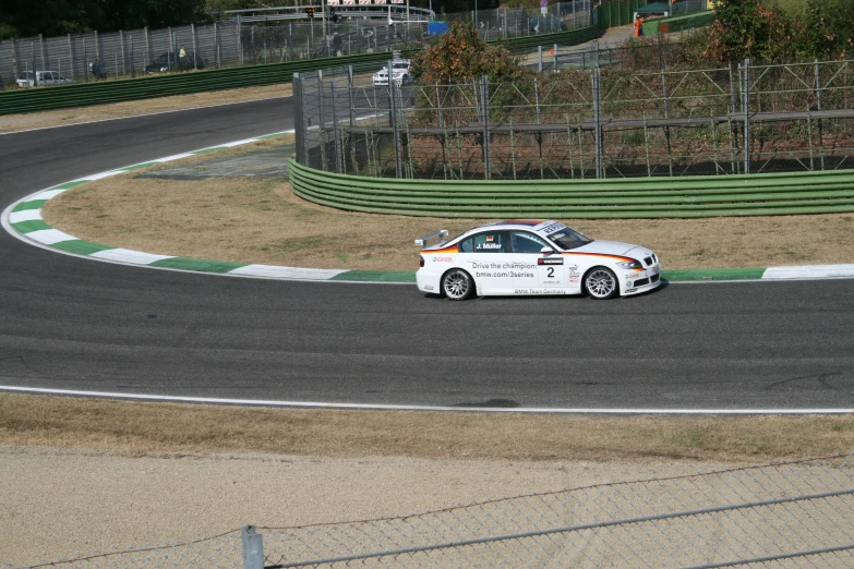 a white car driving on a race track