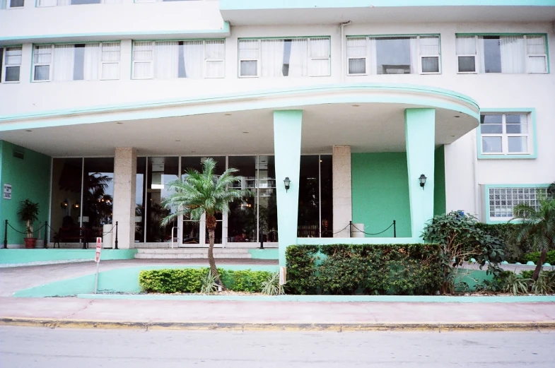 an old building with a palm tree next to it