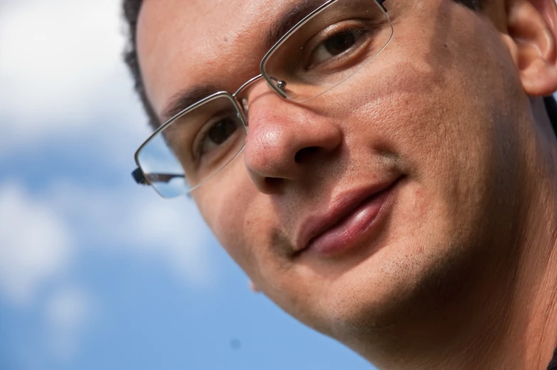 a closeup view of a man wearing glasses