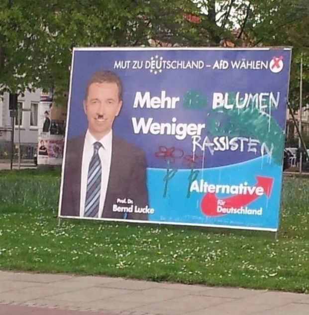 a political poster on the side of a street